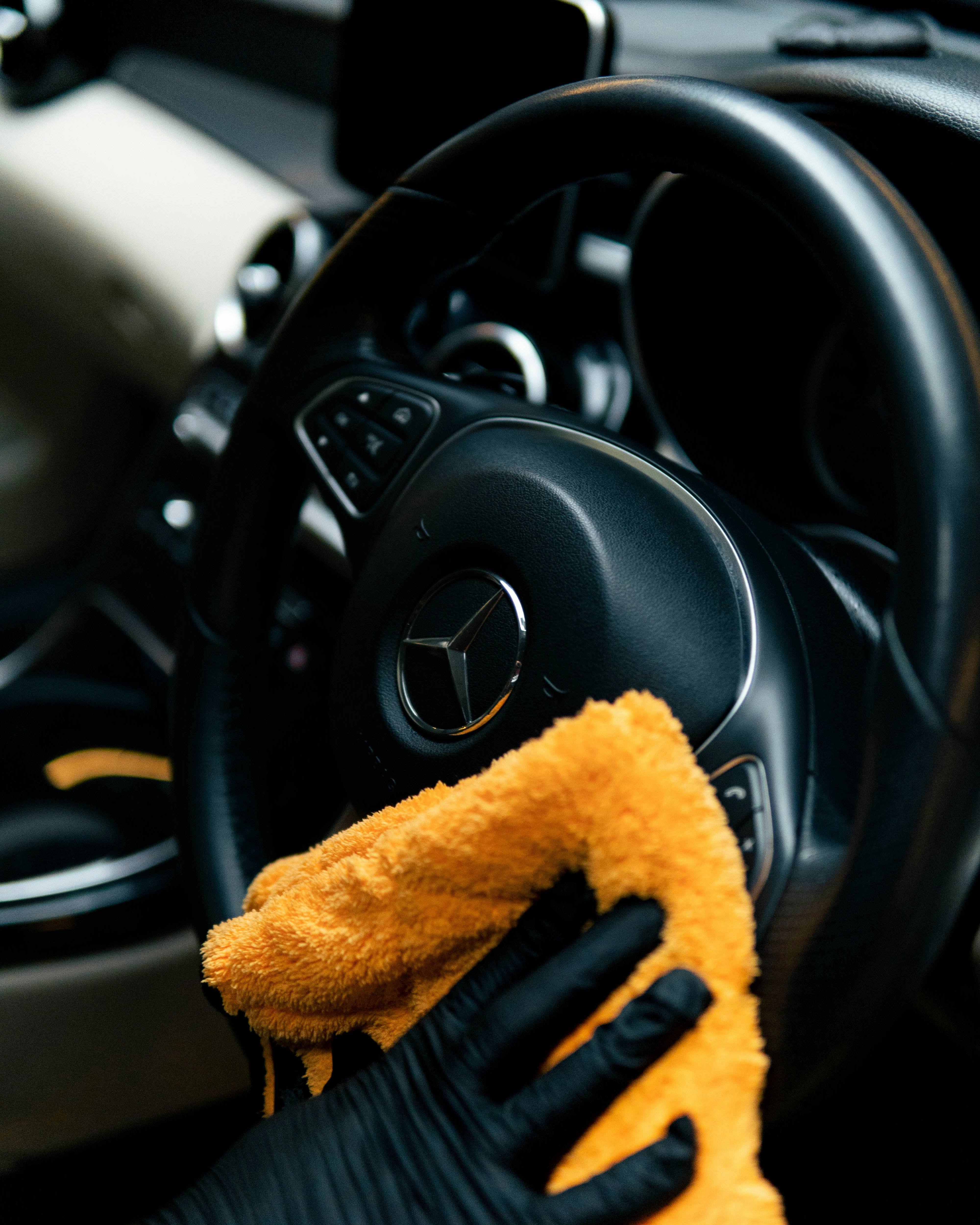 Wiping car steering wheel with microfiber cloth