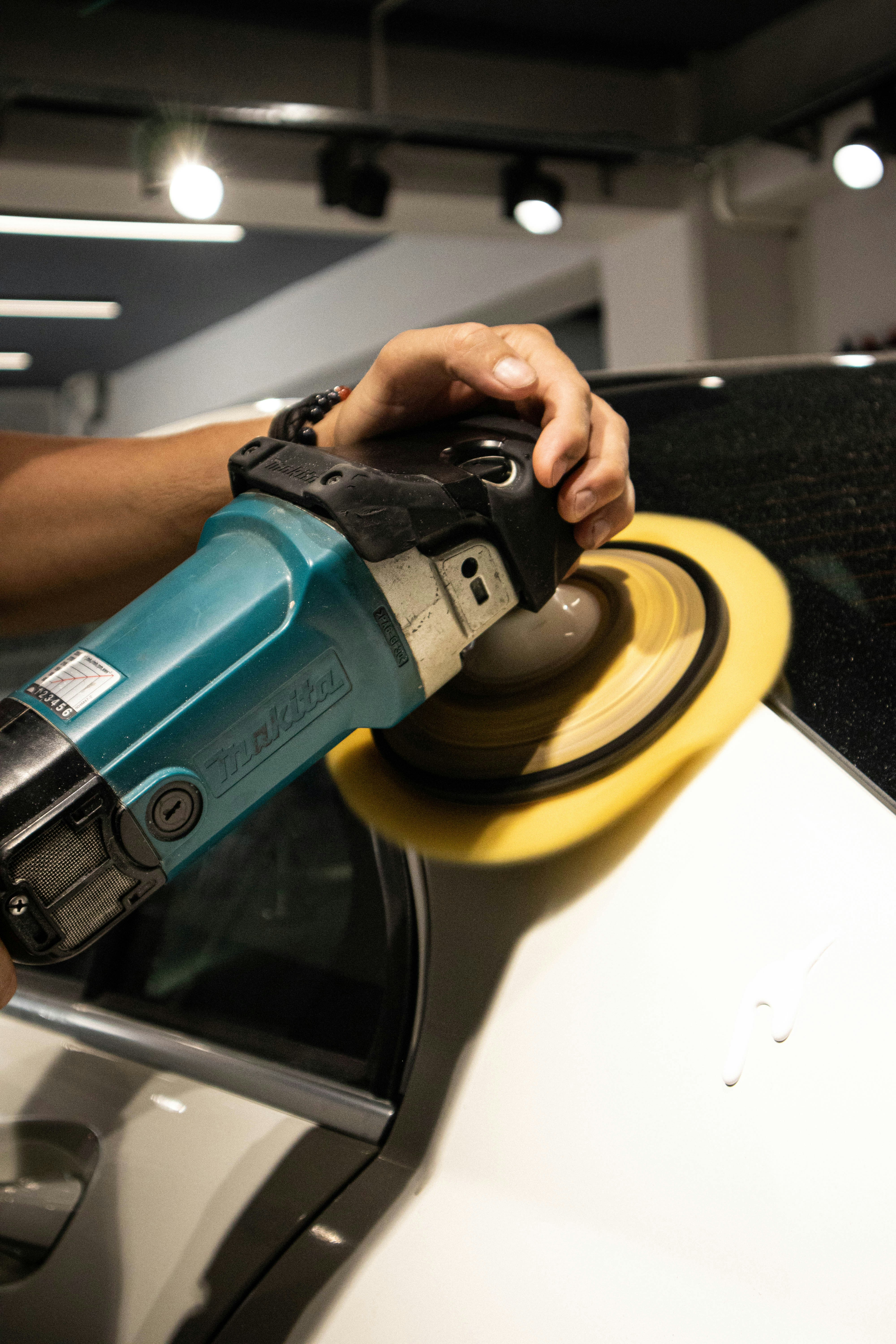 Hand polishing car paint to a high-gloss finish